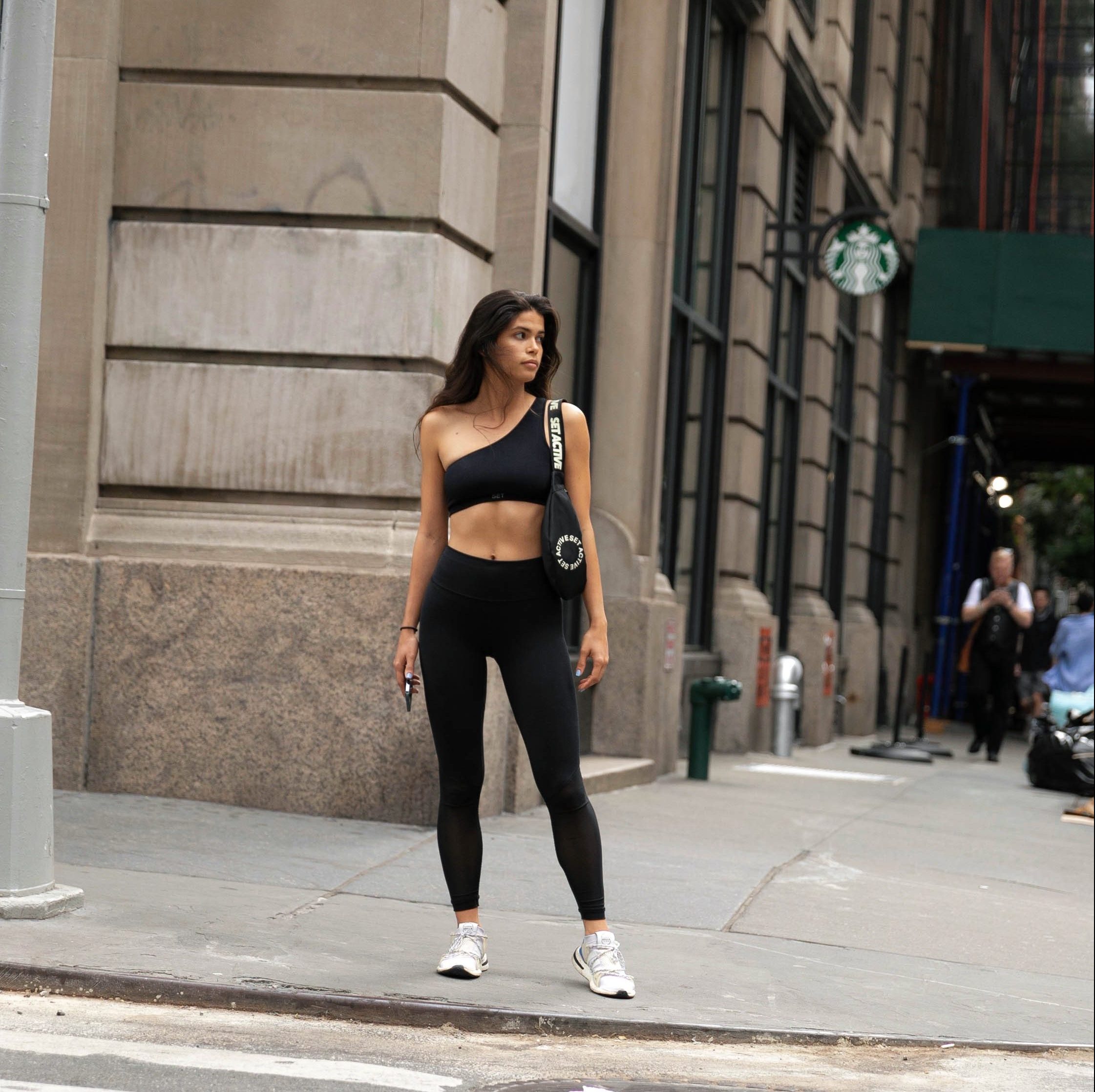 model wearing set active in SoHo New York City Manhattan for a photoshoot with white adidas and black clothes